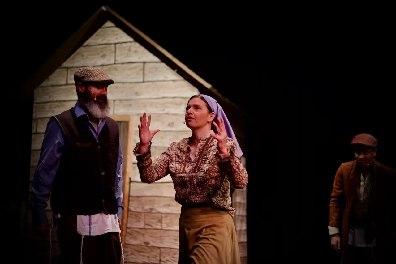 Golde makes her point to Tevye outside the cottage.